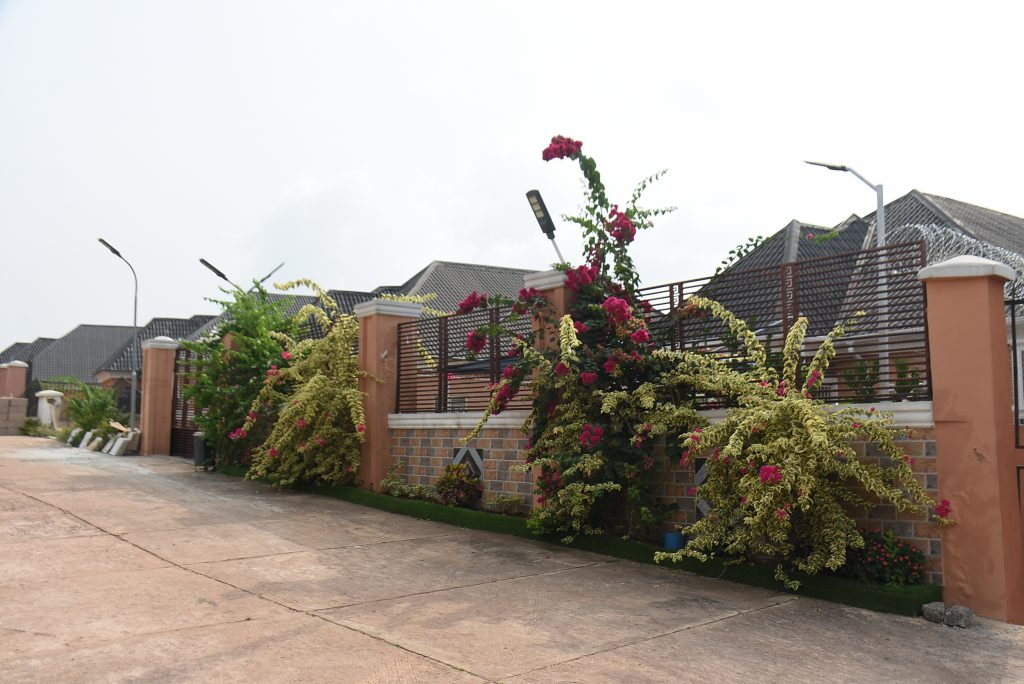Landscaped boundary wall and flowering gardens at Winners Estate